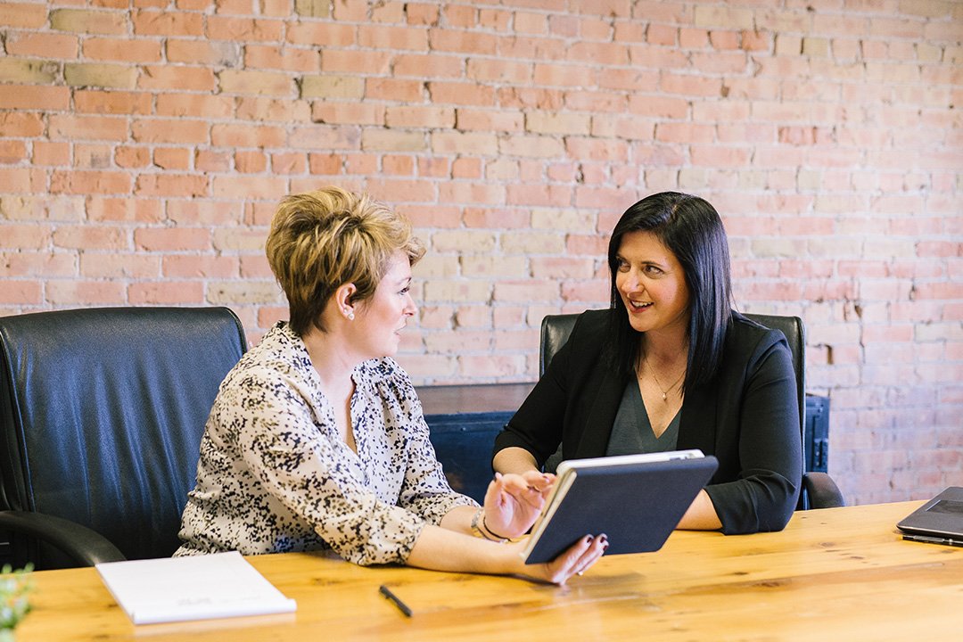 Businesswomen having discussion whilst sitting at a table