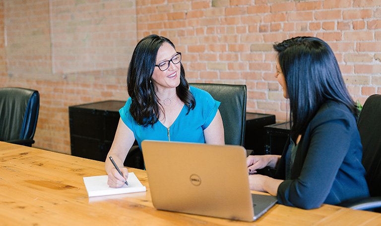 Businesswomen having discussion sitting at a table